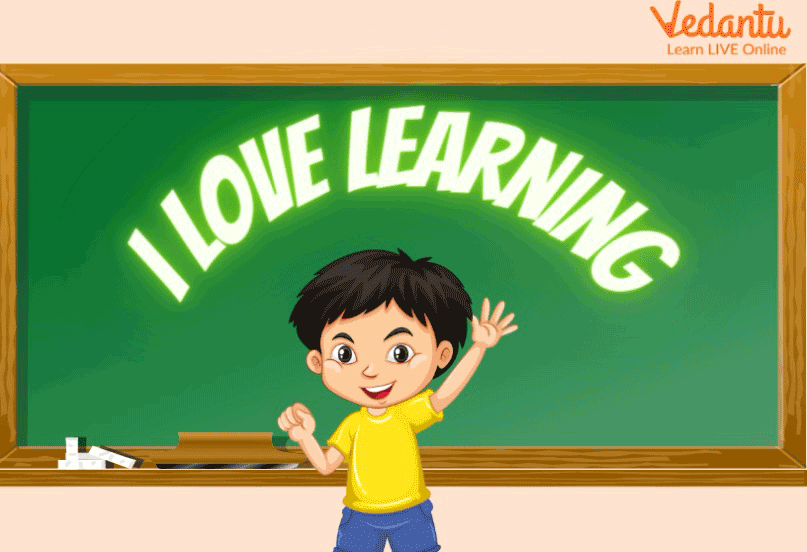 A kid in front of the blackboard with “I love learning” written on it