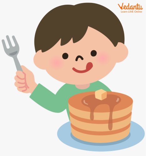 A boy (Rekai) eating pancakes