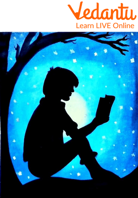 Garrett reading under the splendid and magical tree