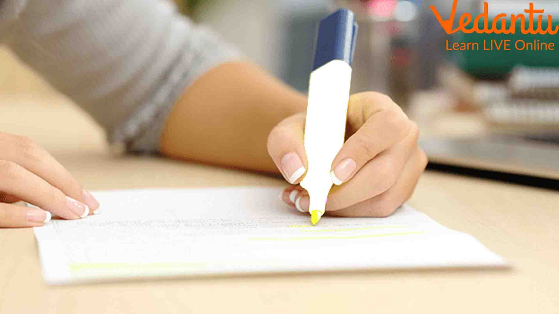 A Girl Highlighting Her Notebook