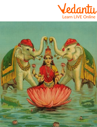 Goddess Lakshmi standing on a lotus holding two lotuses and showering flower petals with two elephants on each of her sides
